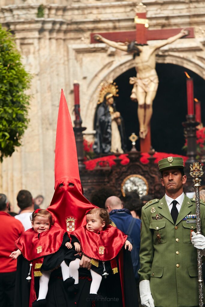 Imágenes del Cristo de la Caridad y Hermano mayor procesionando con sus hijas gemelas.